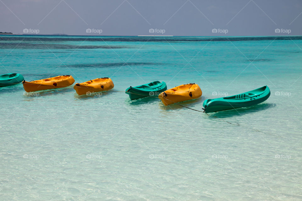 View of kayaks moored in sea