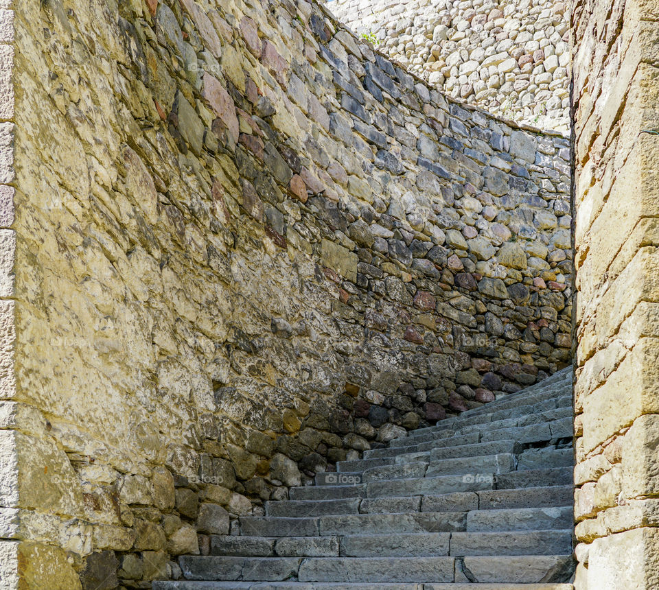 ancient stone wall, winding stone staircase, upstairs