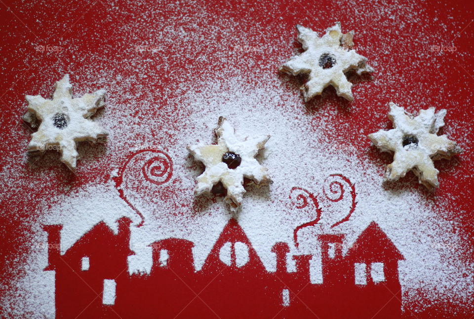 Home made cookies on the background of houses silhouettes of powdered sugar