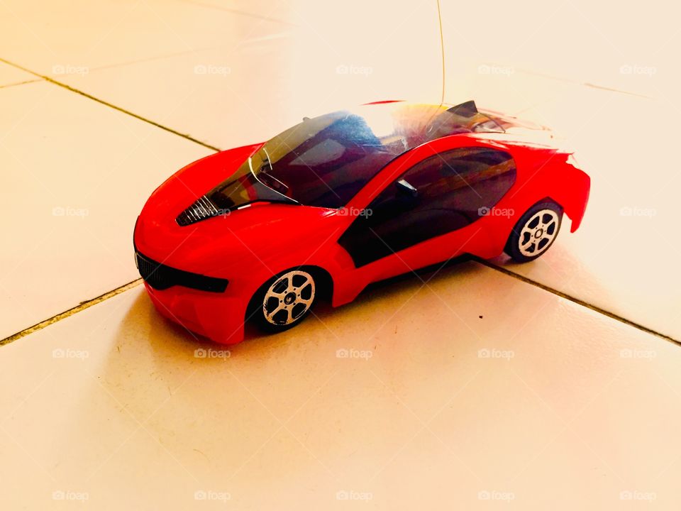 Red car toy on the floor 