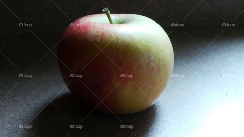 Apple on counter. Morning light on the apple