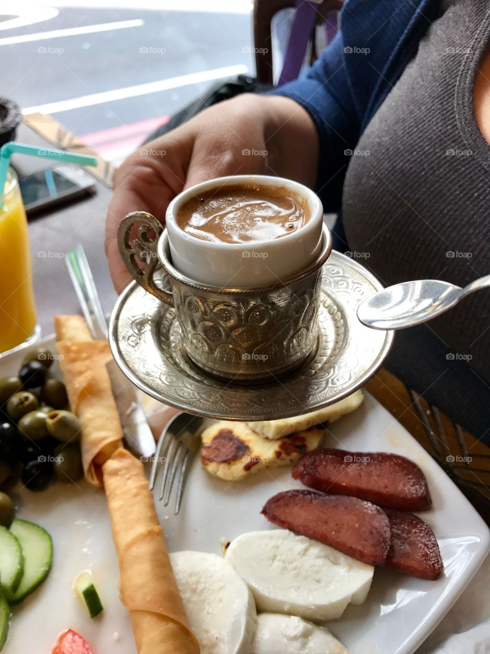 Lady enjoying a Turkish breakfast with tea 
