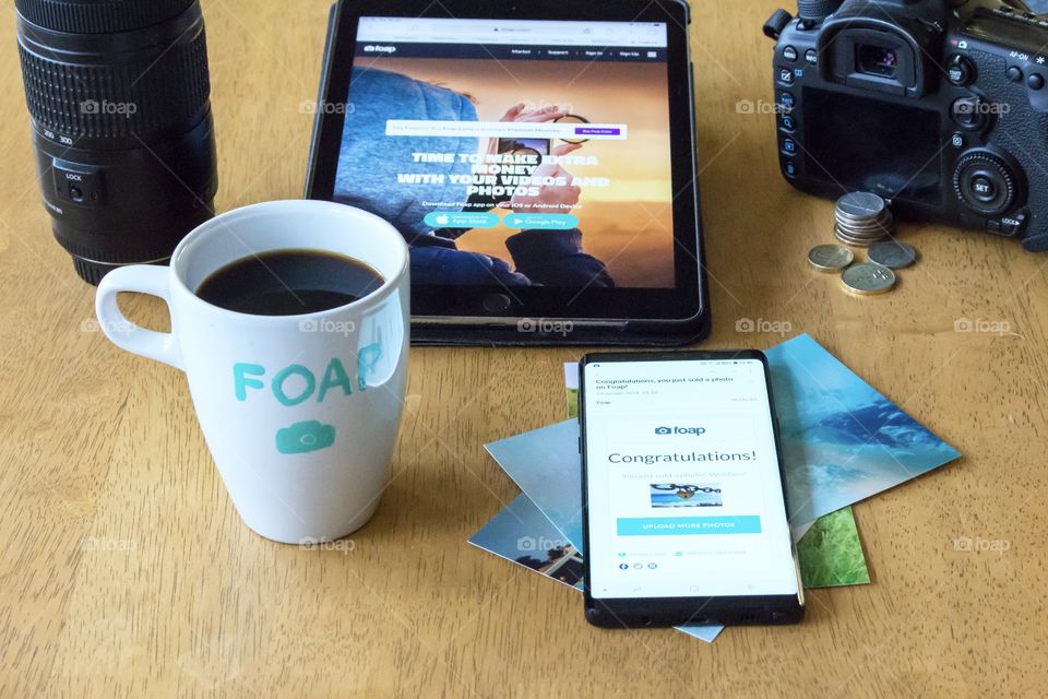 Having coffee in a mug with Foap text on it. Receiving e-mail about selling a picture.