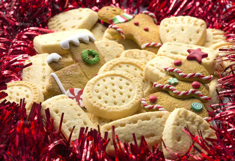 Christmas Treats, delicious, crisp, shortbread biscuits sorrounded by red tinsel.