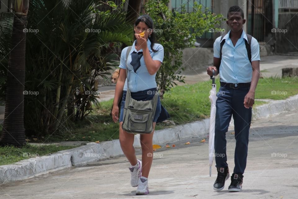 Two Teenagers In Blue Uniform Walk Home After School ,Guantanamo,Cuba
