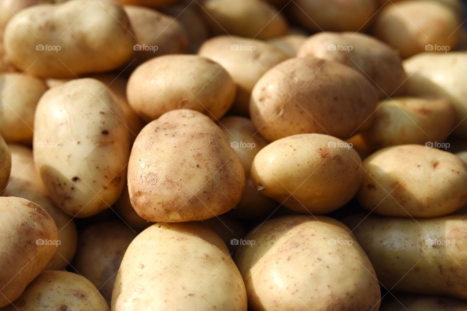 fresh food potatoes at the market sellers ware