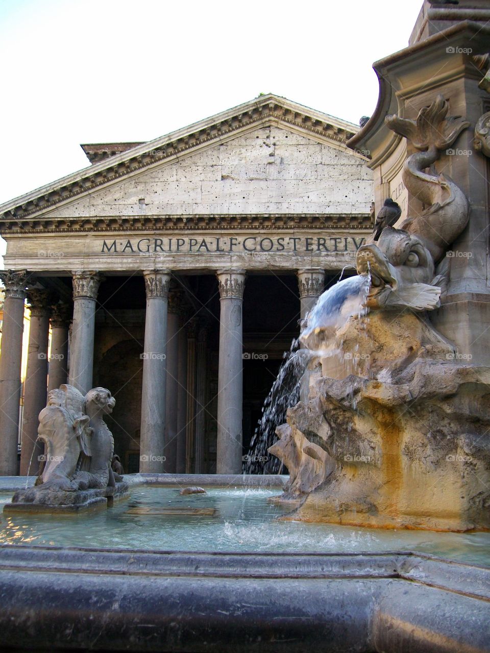 Looking over the fountain towards the entrance of the Pantheon with the morning light peaking through its columns