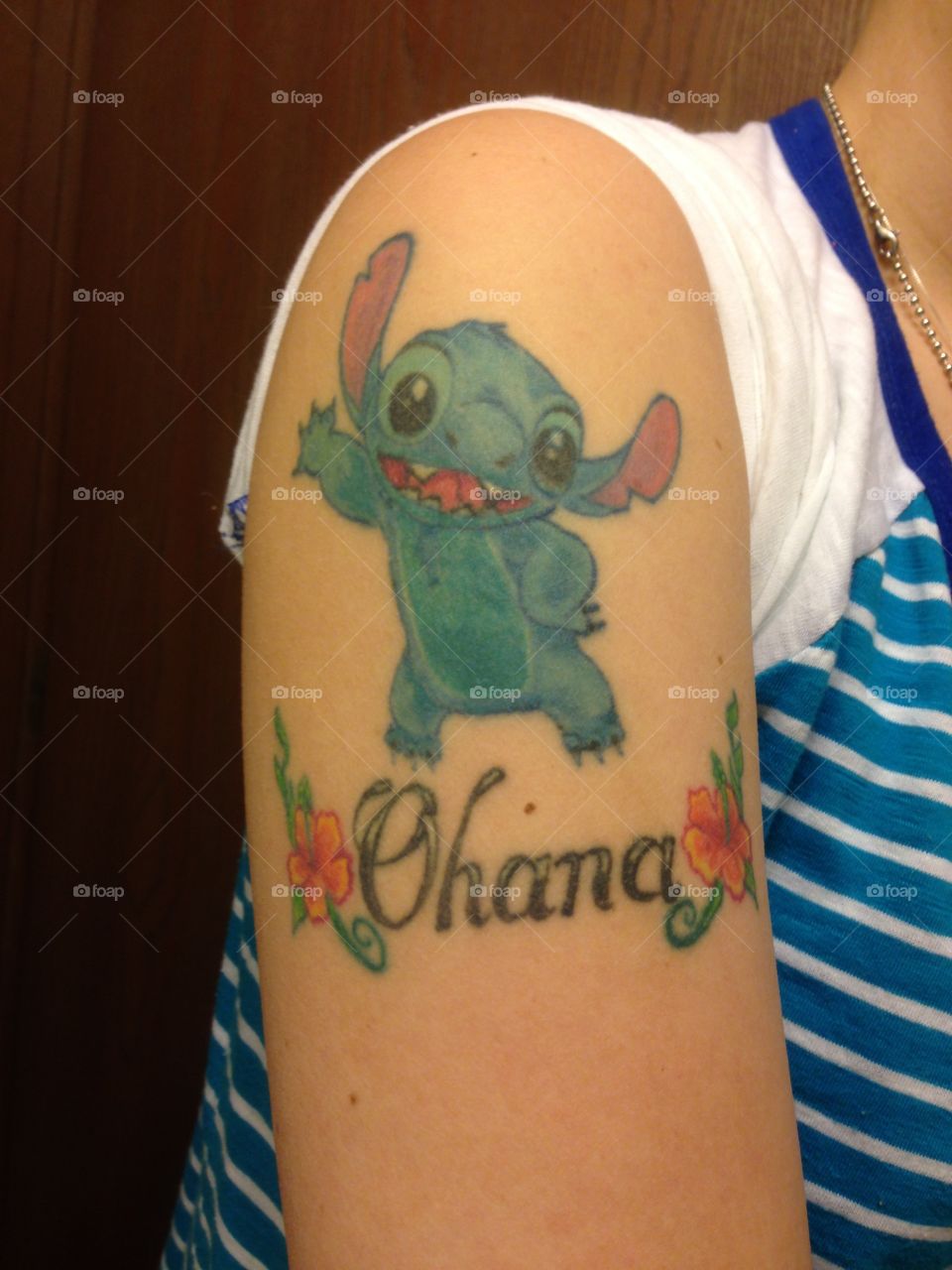 I got this tattoo in 2010 after I had gone through many years of kidney surgeries & finally had to have my kidney removed, my family was there every step of the way. I got Ohana because it means Family, and family is so special to me. The Disney Stitch movie was my favorite & because of what he says Ohana means. This tattoo means so much to me. It reminds of how much my family means to me and how much you need family. 