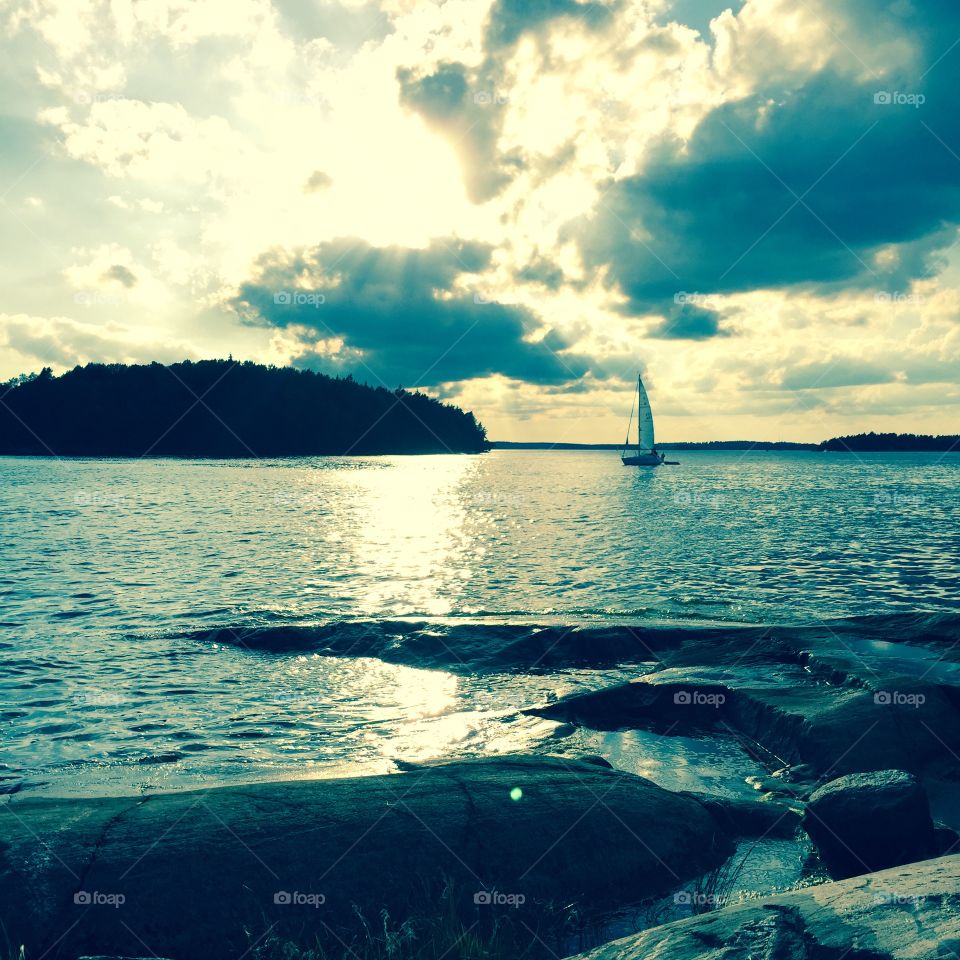 Sailing in Sweden. A  sailboat in the distance. In the archipelago of Stockholm, Sweden. 