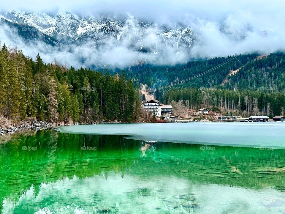 Frozen lake in winter alpine mountains