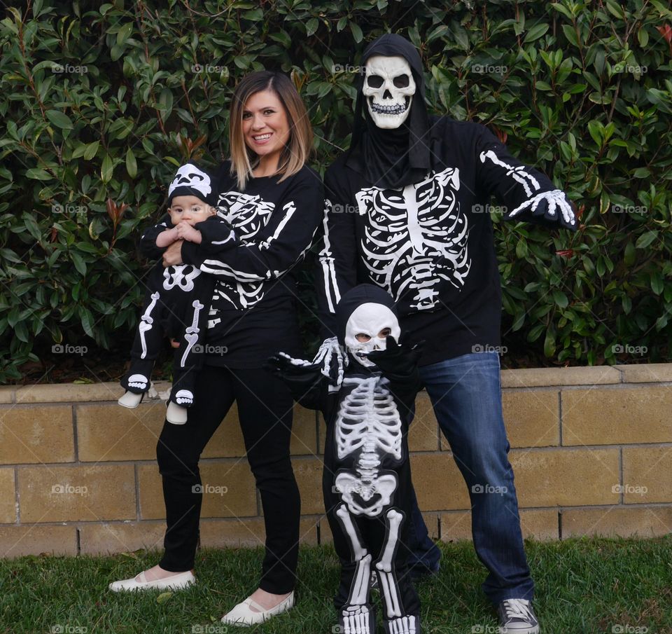 Family in skeleton costume outdoors