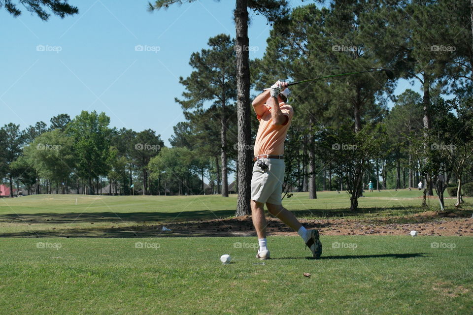 Man playing golf on a golf course