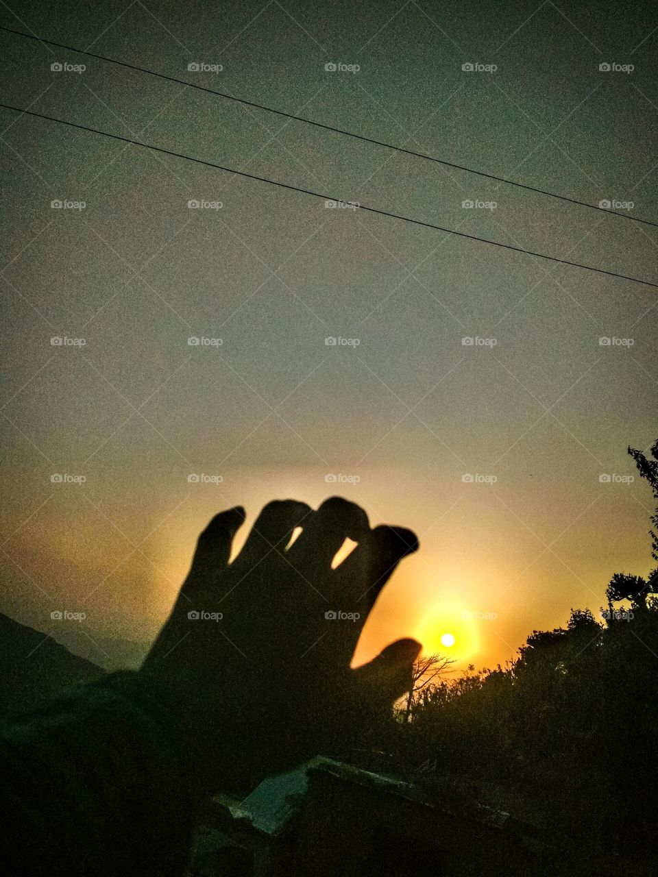 hand and sunset view