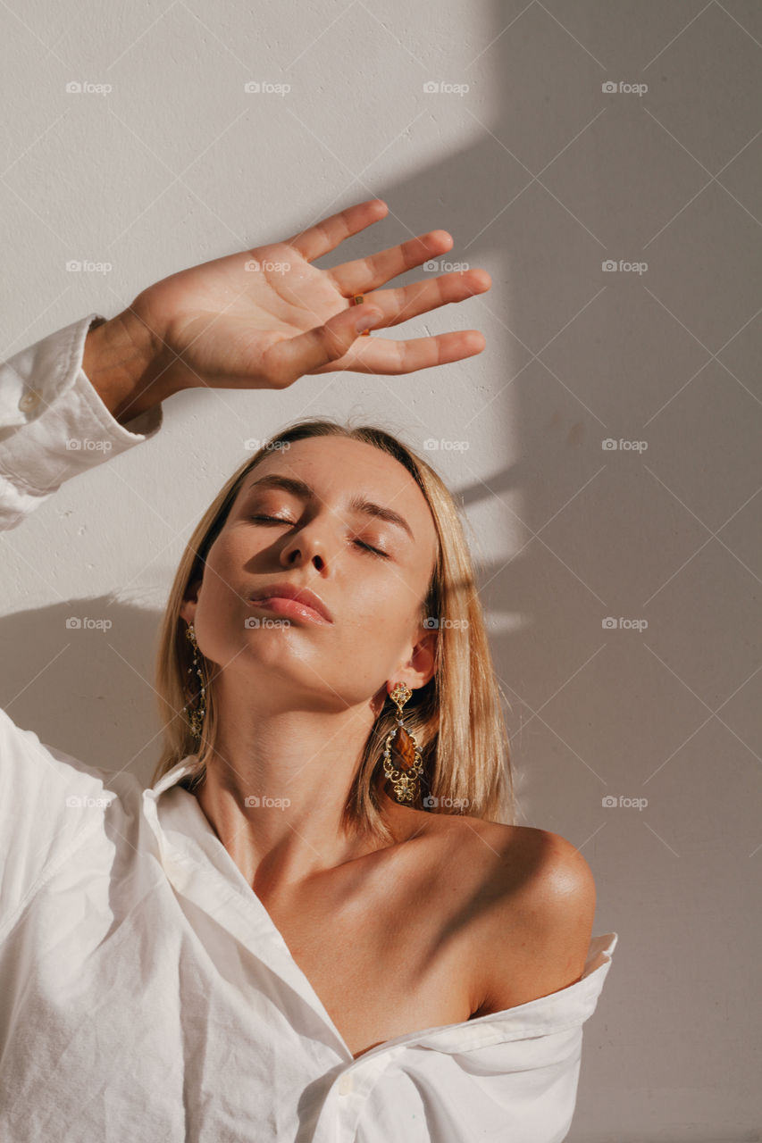 confident woman in white shirt on white background