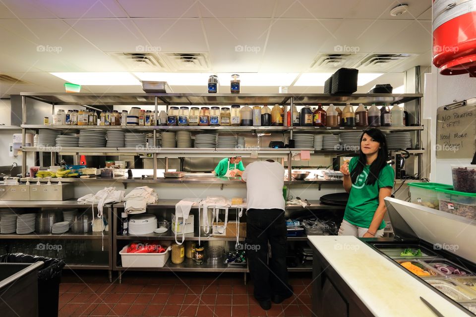 Cook chef worker inside the kitchen of the restaurant 