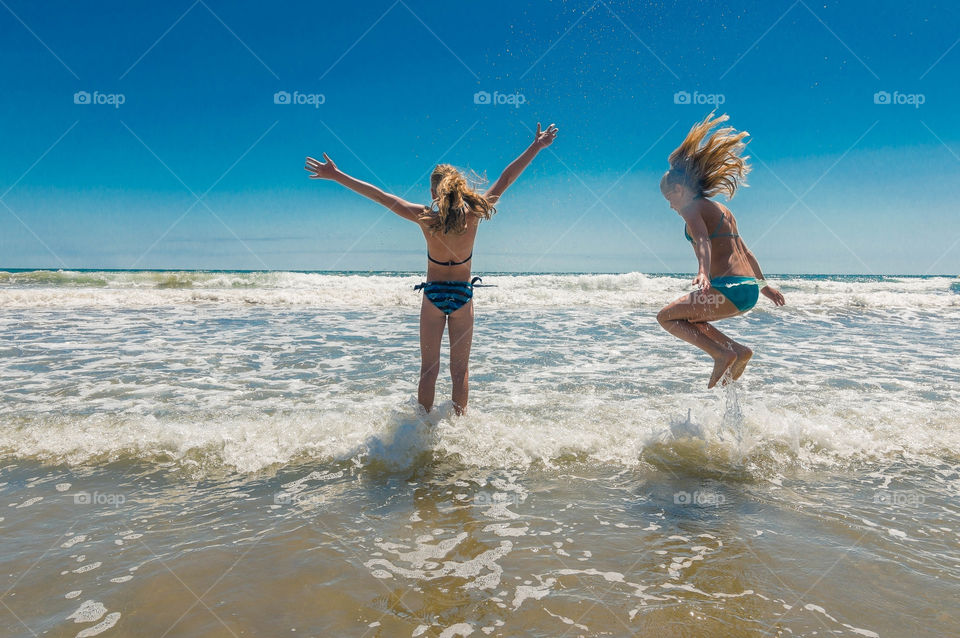 Summer vibes, jumping into the sea, playing with waves