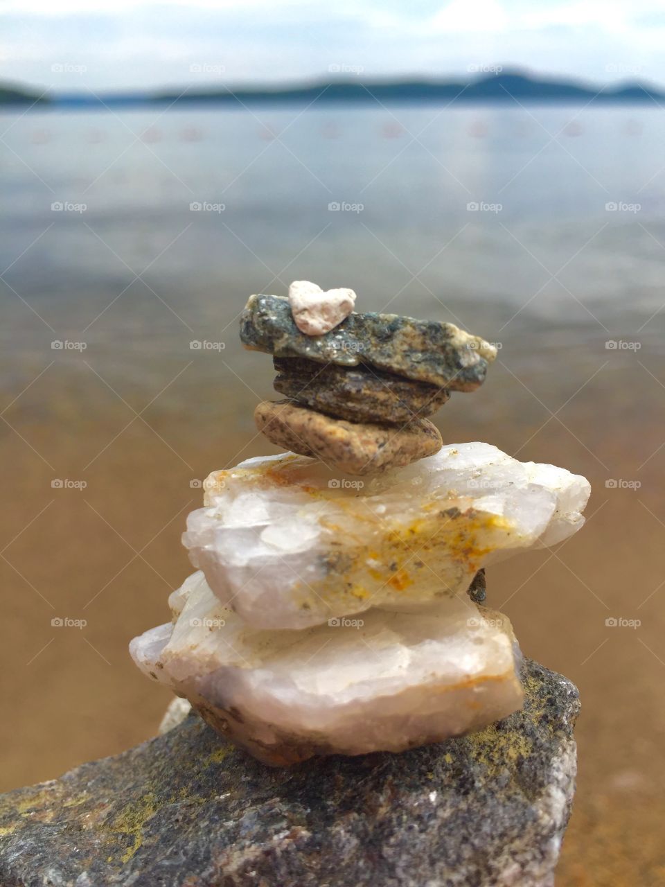 Rock pile cairn with small heart shaped rock on top