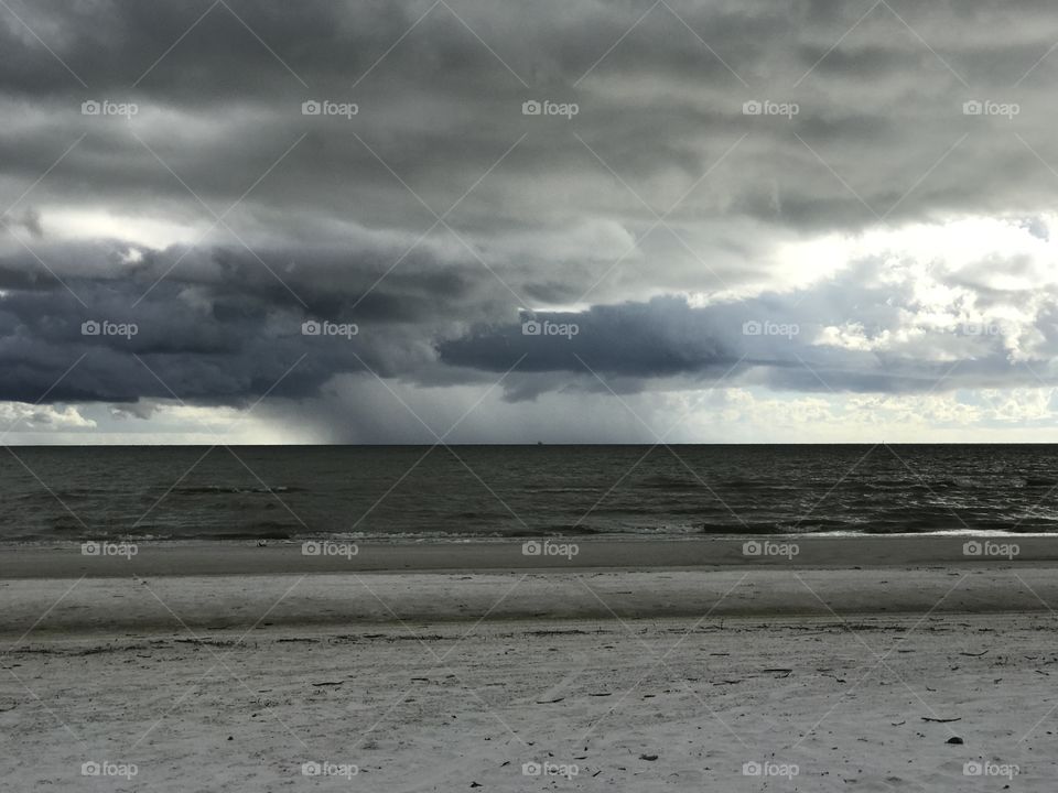 Storm clouds over idyllic beach