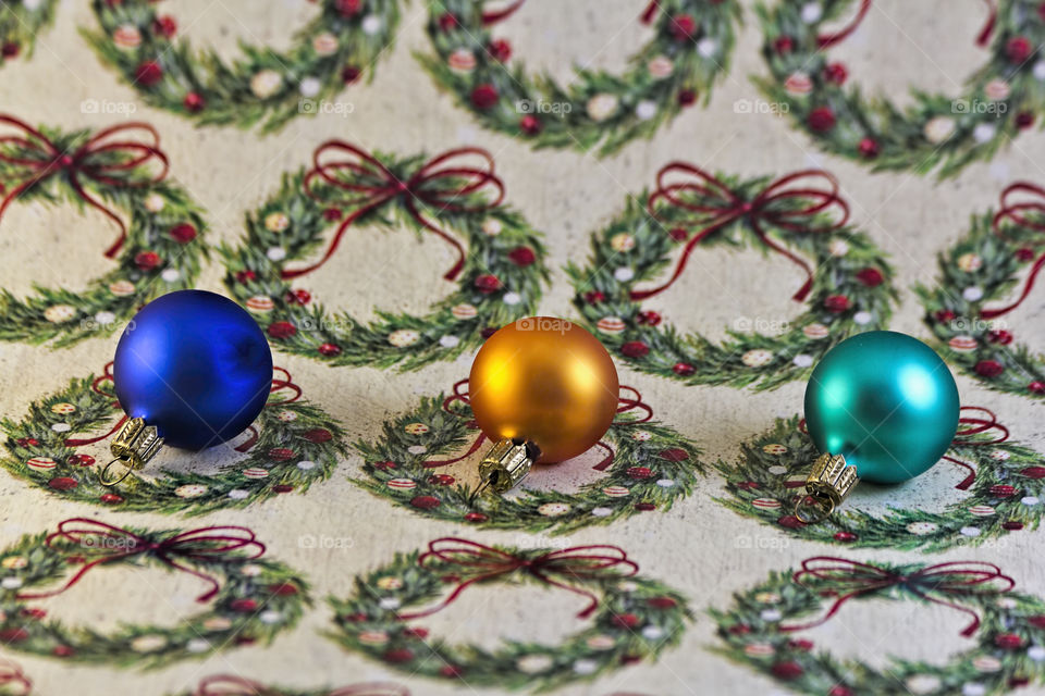 Three Xmas ornaments on wrapping paper 