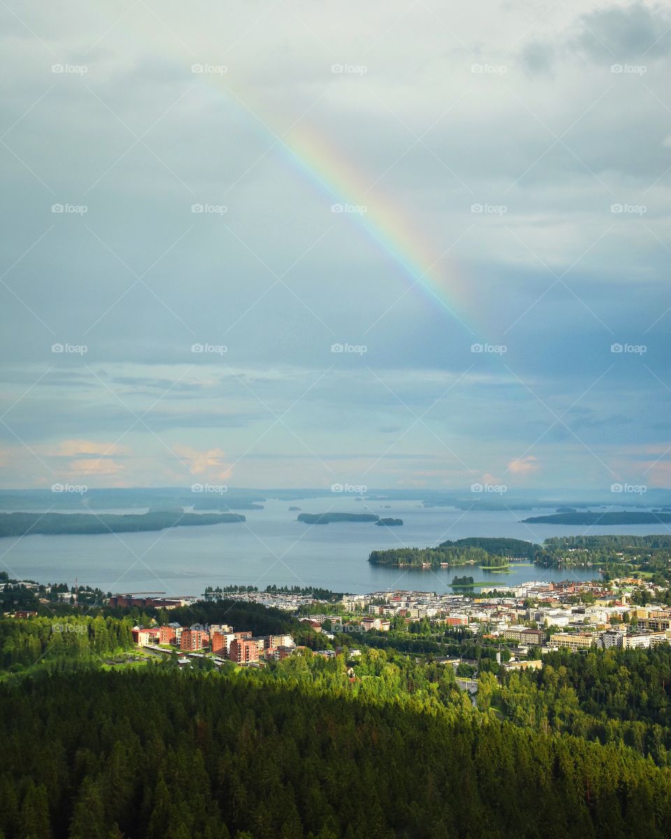 View of rainbow in sea with town