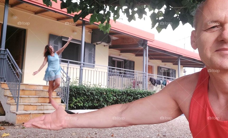 Happy man and woman in front of the house