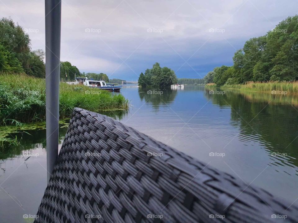View from a boat on a lake. Further back in the sky it was busy with lightnings. then rain followed.