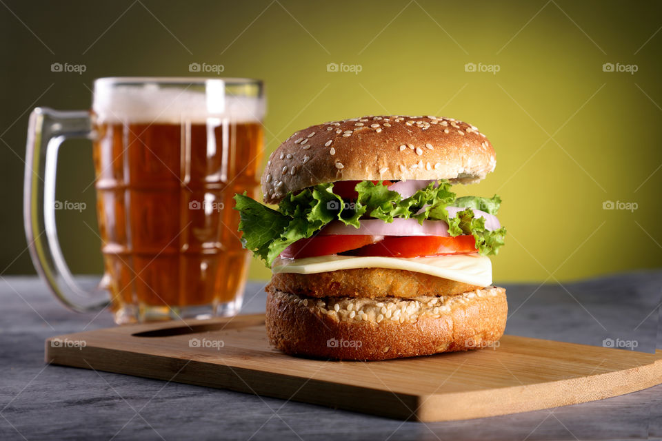 Fast food burger with beer mug