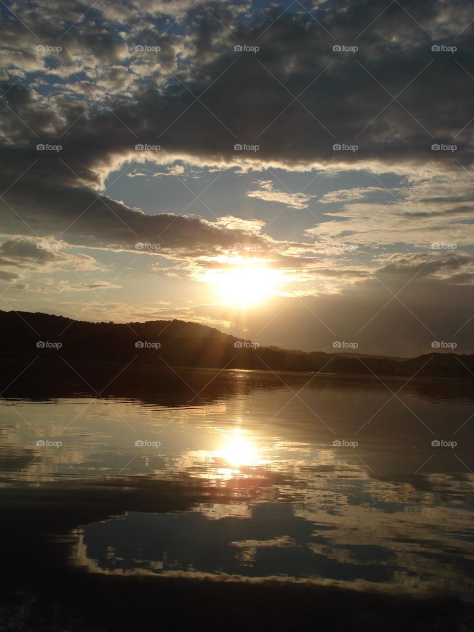 River sunset with clouds reflection