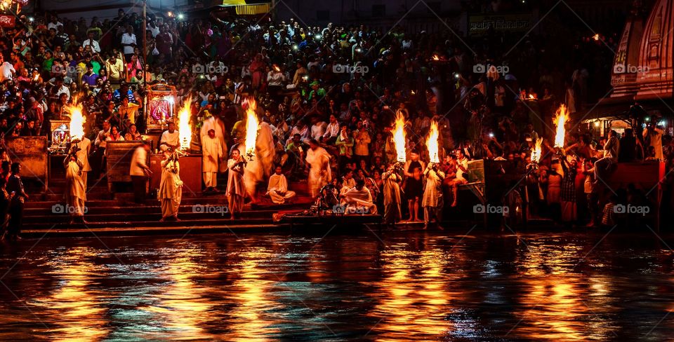 Indian priests performing evening ritual at the banks of holy ganga river at Haridwar