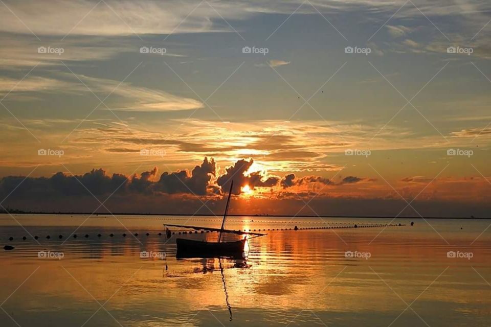 boat sunset sky sea lake reflection
