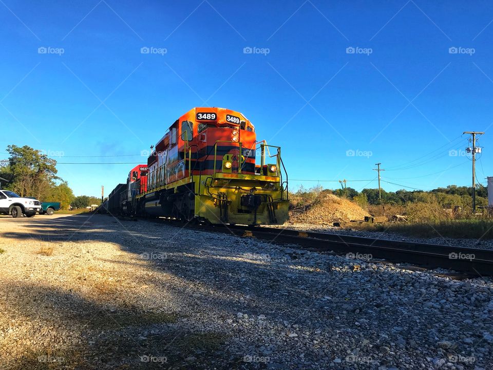 Yellow and orange train on railroad tracks 