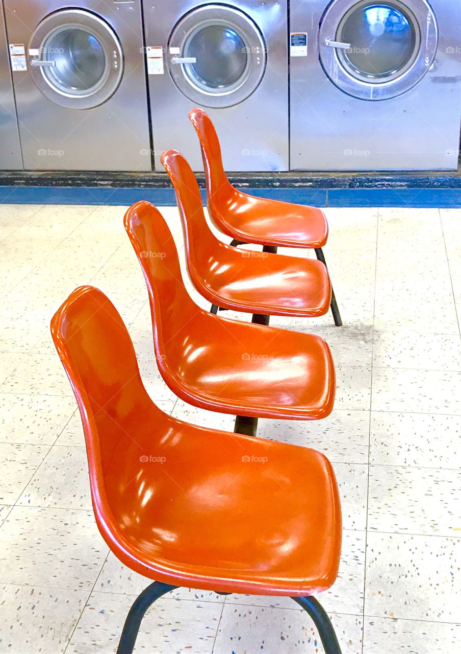 Orange Chairs in Laundromat