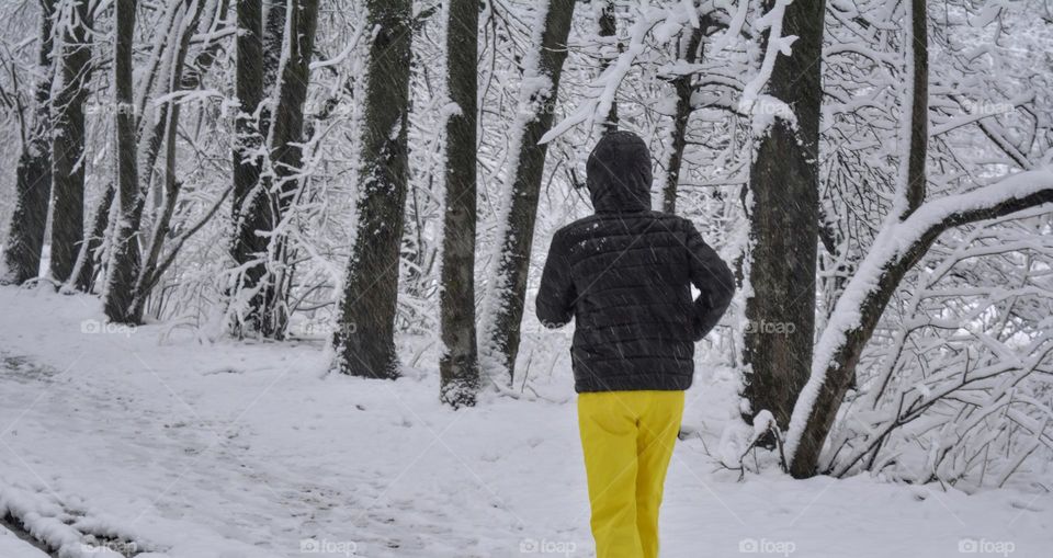 person running in the winter snowy park