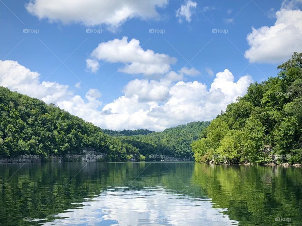 Beautiful day out on the lake with waters so smooth they reflect the clouds in the sky 