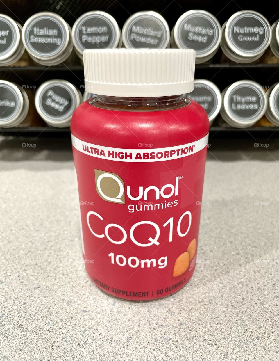 CoQ10 bottle of medicine, medication in a bottle, using medication and supplements, staying healthy with supplements 