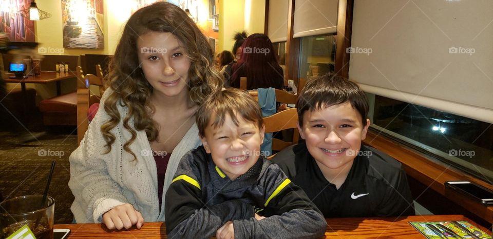 A Young Woman With Siblings Eating Out