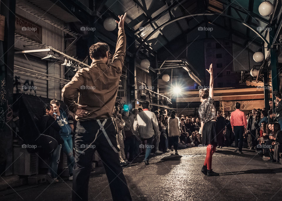 Street Dancing In The Night With Crowd Of People Watching
