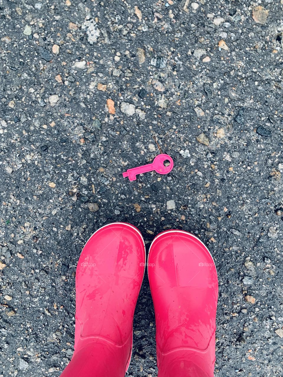 Find a clue. Pink rain boots and plastic key 