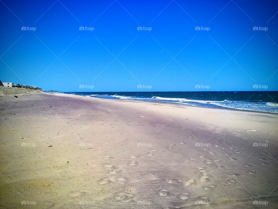 Blue sky meet the waves at the edge of long island sound. Beach sand and tranquility at Montauk