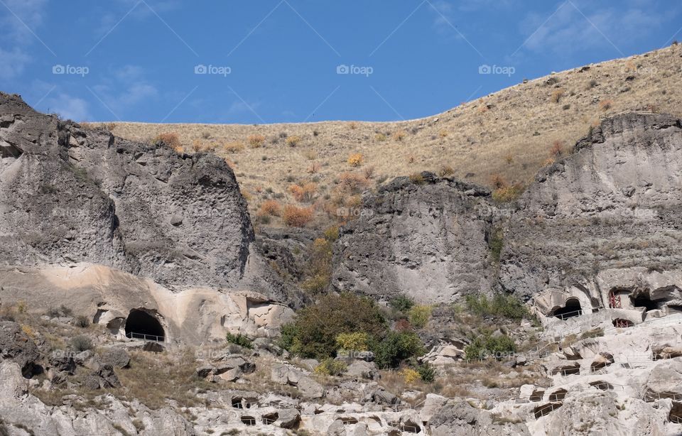 Beautiful cave town of Georgia, Vardzia cave monastery on blue sky background 