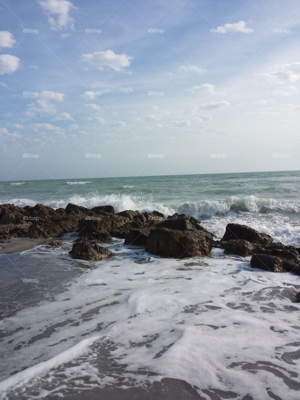 Caspersen Beach. The tide came in to crash on the rocks as we searched for shark teeth at this beach in Sarasota.