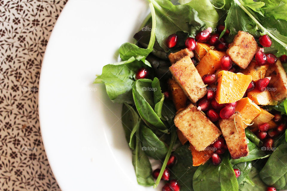 Salad with tofu and sweet potatoes and pomegranate 