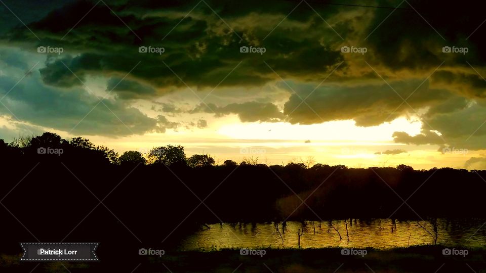 sunsetting with clouds over water