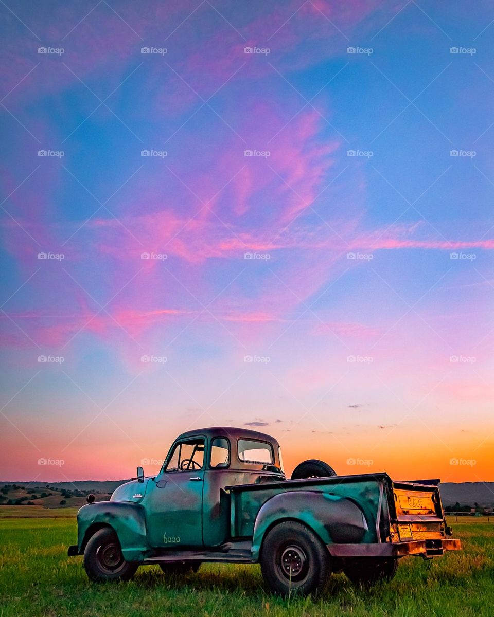 old truck watching the colorful sunset