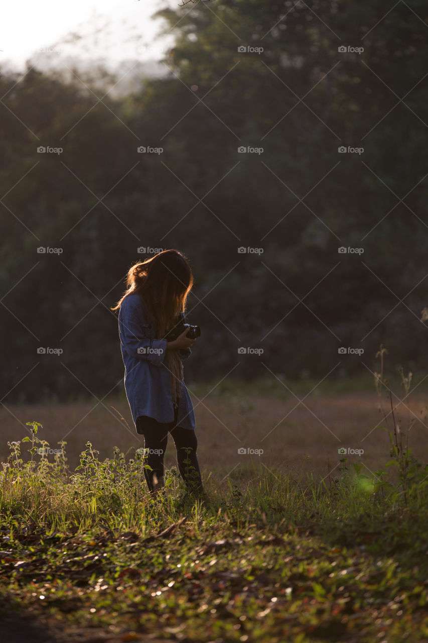 Female tourist photographer in the field 