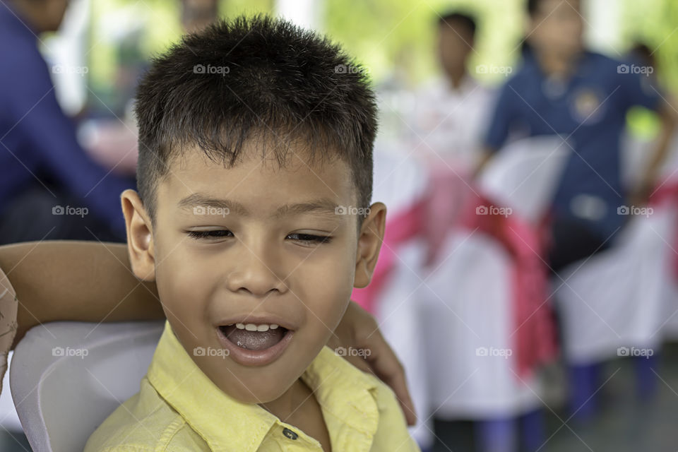 Portrait of Asian boy wisecracking and The blurry background.