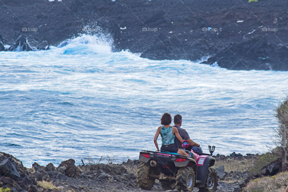 Having fun riding ATV on a rocky seashore