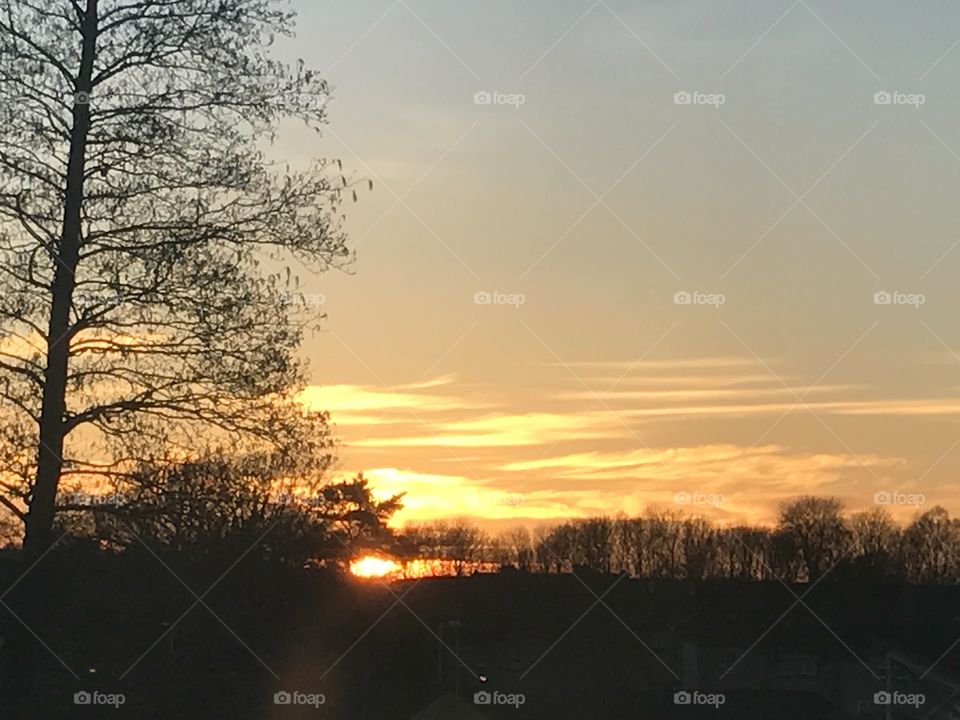 A beautiful sunset with different colours throughout the sky and a silhouette view at the bottom of the picture making this a fabulous view at the beginning of spring 