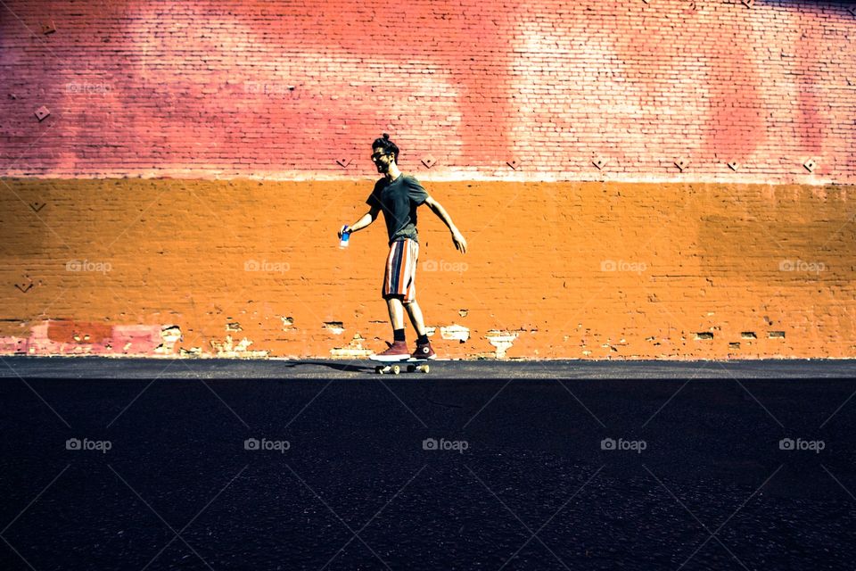 orange wall behind skater