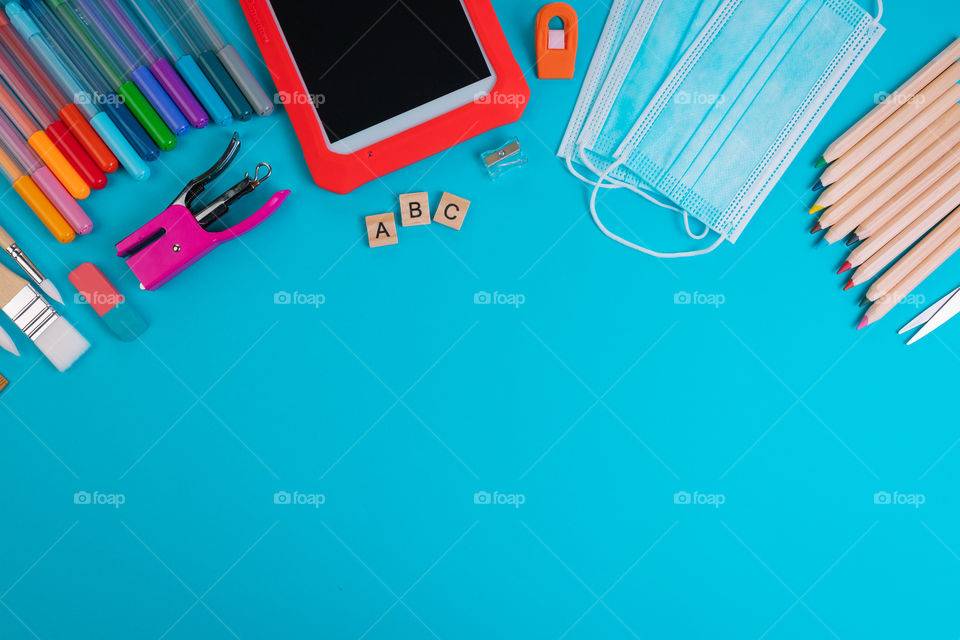 Set of school items on a blue background. Back to school concept. Top view. Copy space